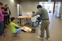 First aiders apply AED to save the personnel with cardiac arrhythmias (simulated scenario)